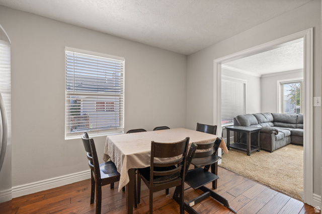 594 850 West Provo, UT 84601 - Photo 8 of 33 Dining area featuring wood-finish flooring, a rectangular window with blinds, and light-toned wall paint