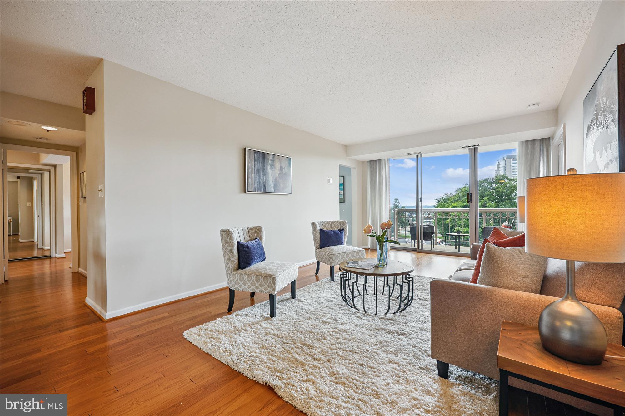 5800 Nicholson Lane, Unit 1908 Rockville, MD 20852 - Photo 1 of 35 a living room with furniture a large window and wooden floor
