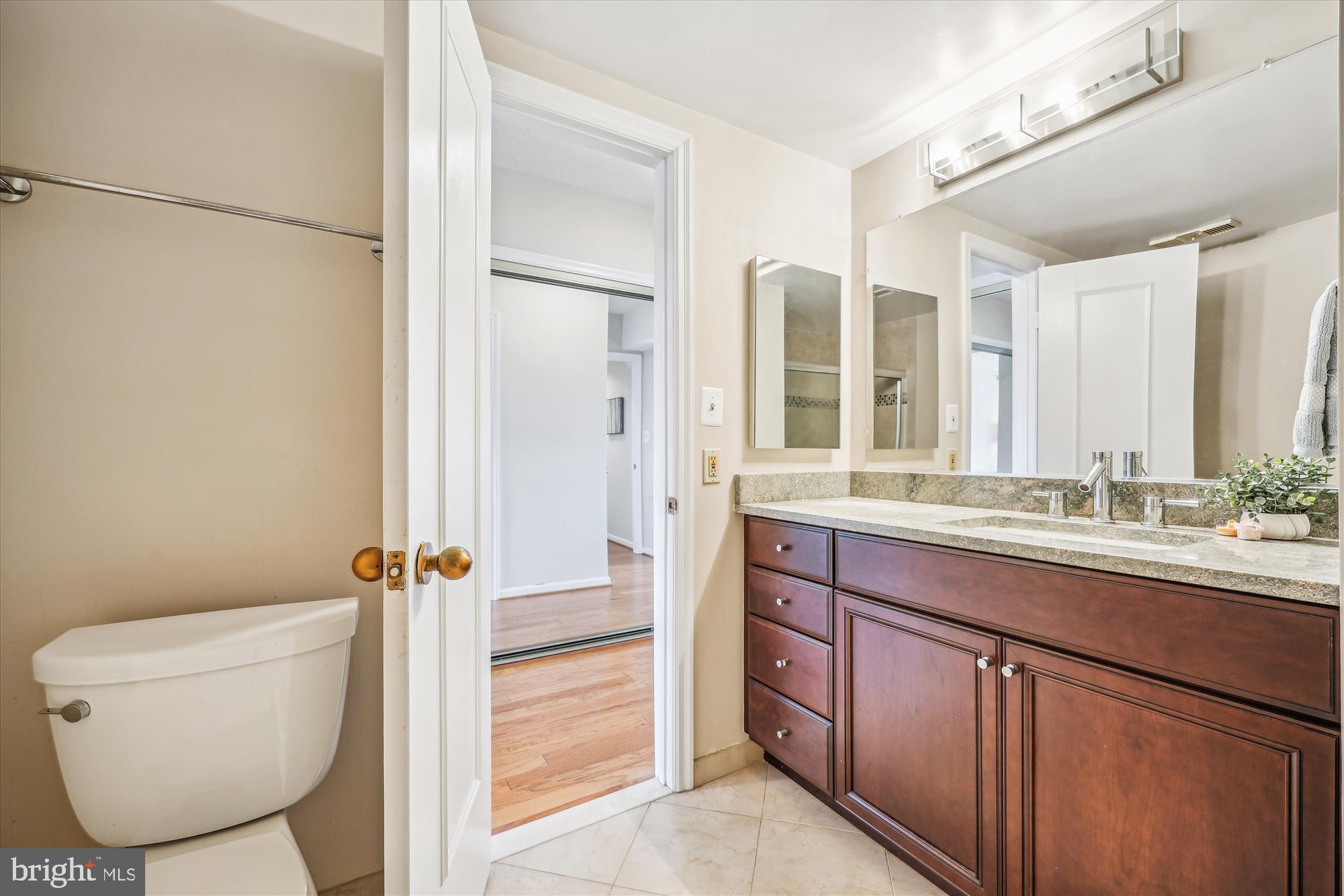 5800 Nicholson Lane, Unit 1908 Rockville, MD 20852 - Photo 14 of 35 a bathroom with a granite countertop sink toilet and shower