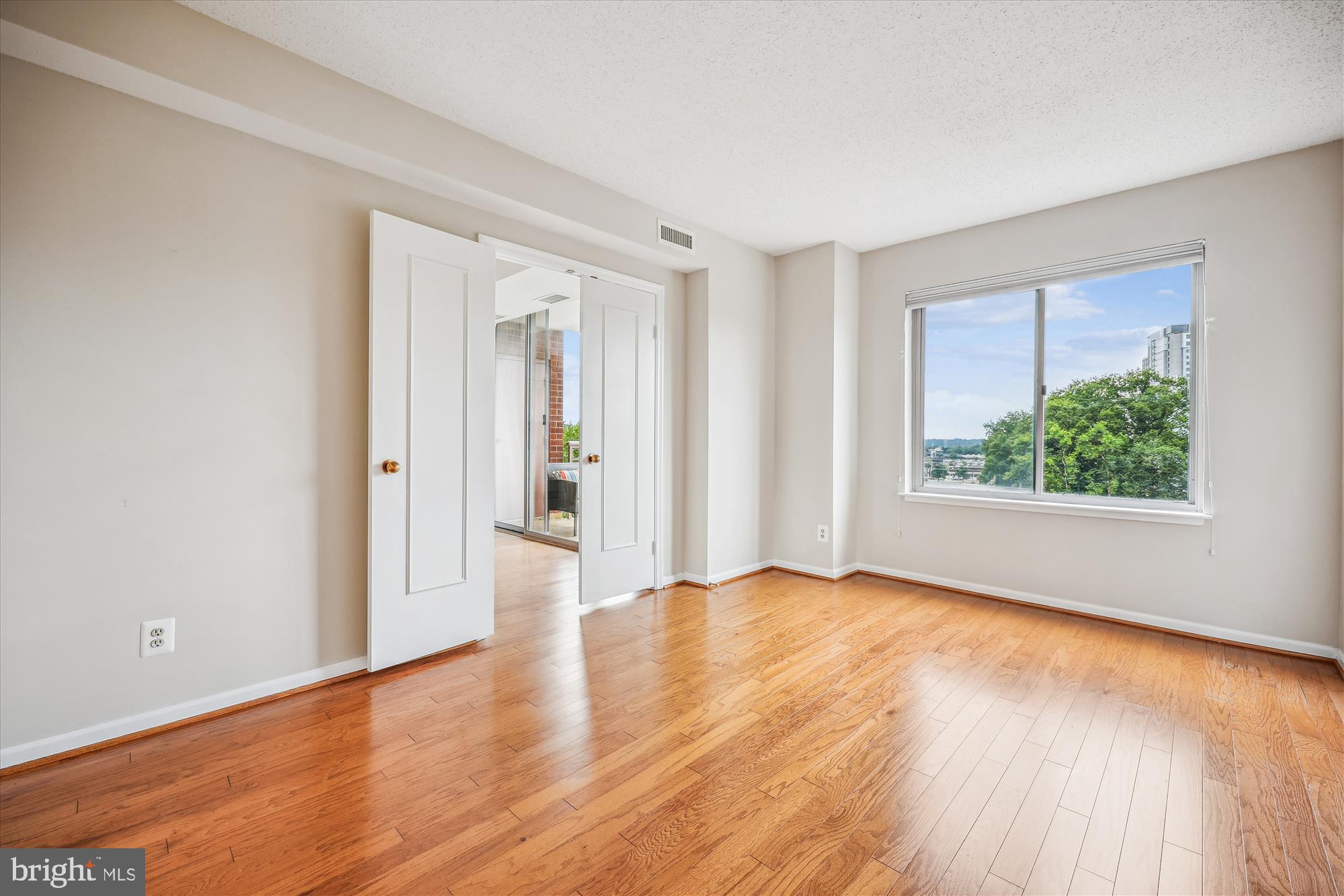 5800 Nicholson Lane, Unit 1908 Rockville, MD 20852 - Photo 15 of 35 a view of an empty room with wooden floor and a window