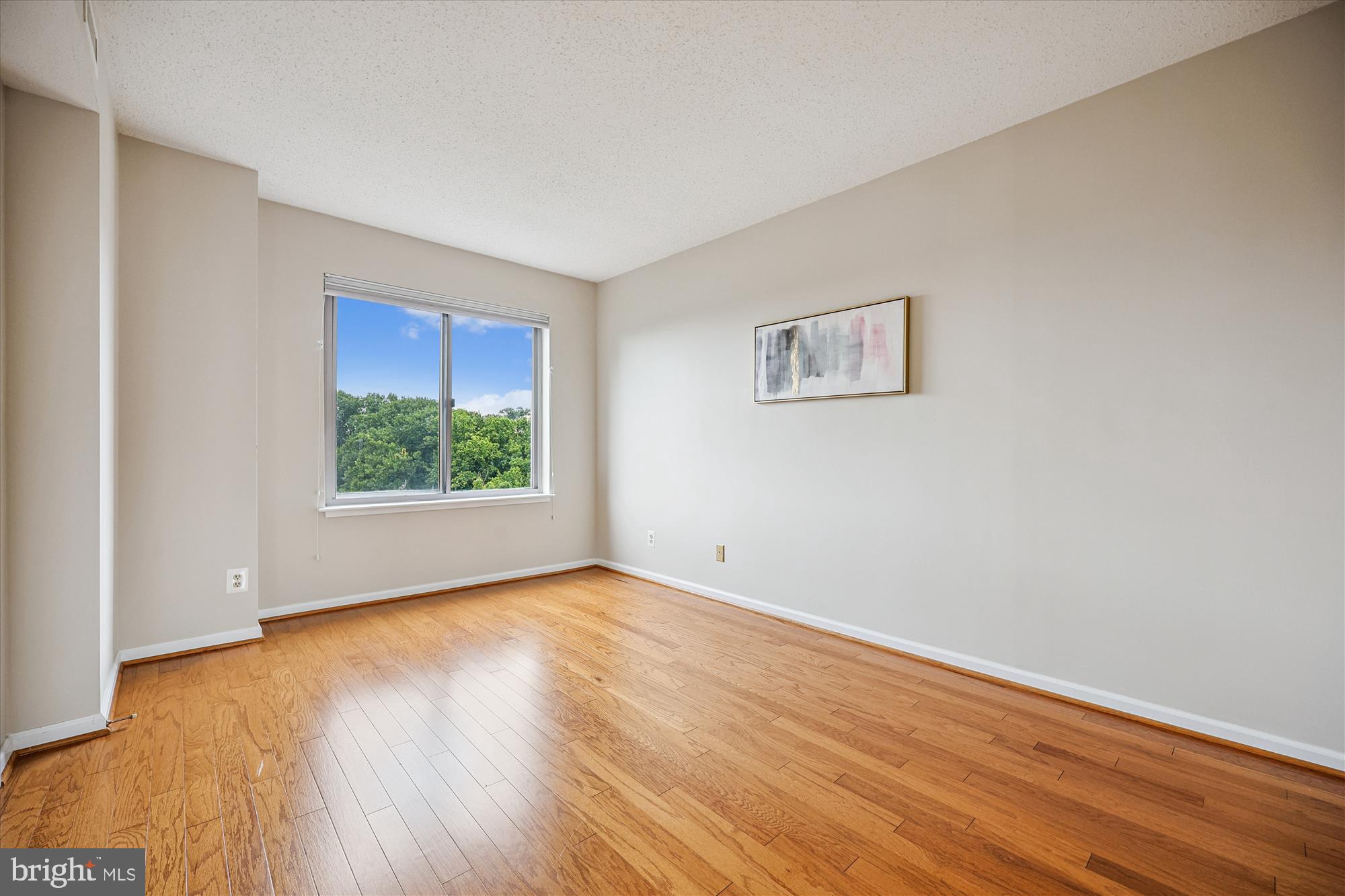 5800 Nicholson Lane, Unit 1908 Rockville, MD 20852 - Photo 16 of 35 a view of an empty room with wooden floor and a window