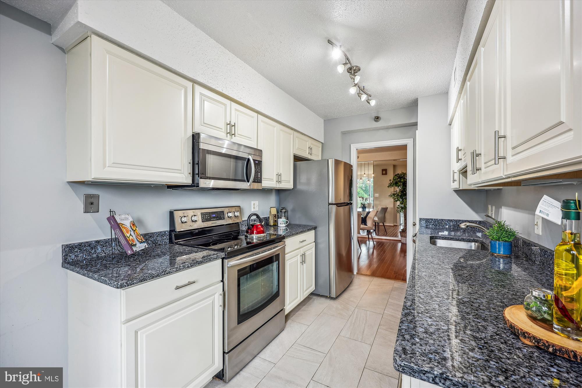 5800 Nicholson Lane, Unit 1908 Rockville, MD 20852 - Photo 8 of 35 a kitchen with stainless steel appliances granite countertop a stove sink microwave and cabinets