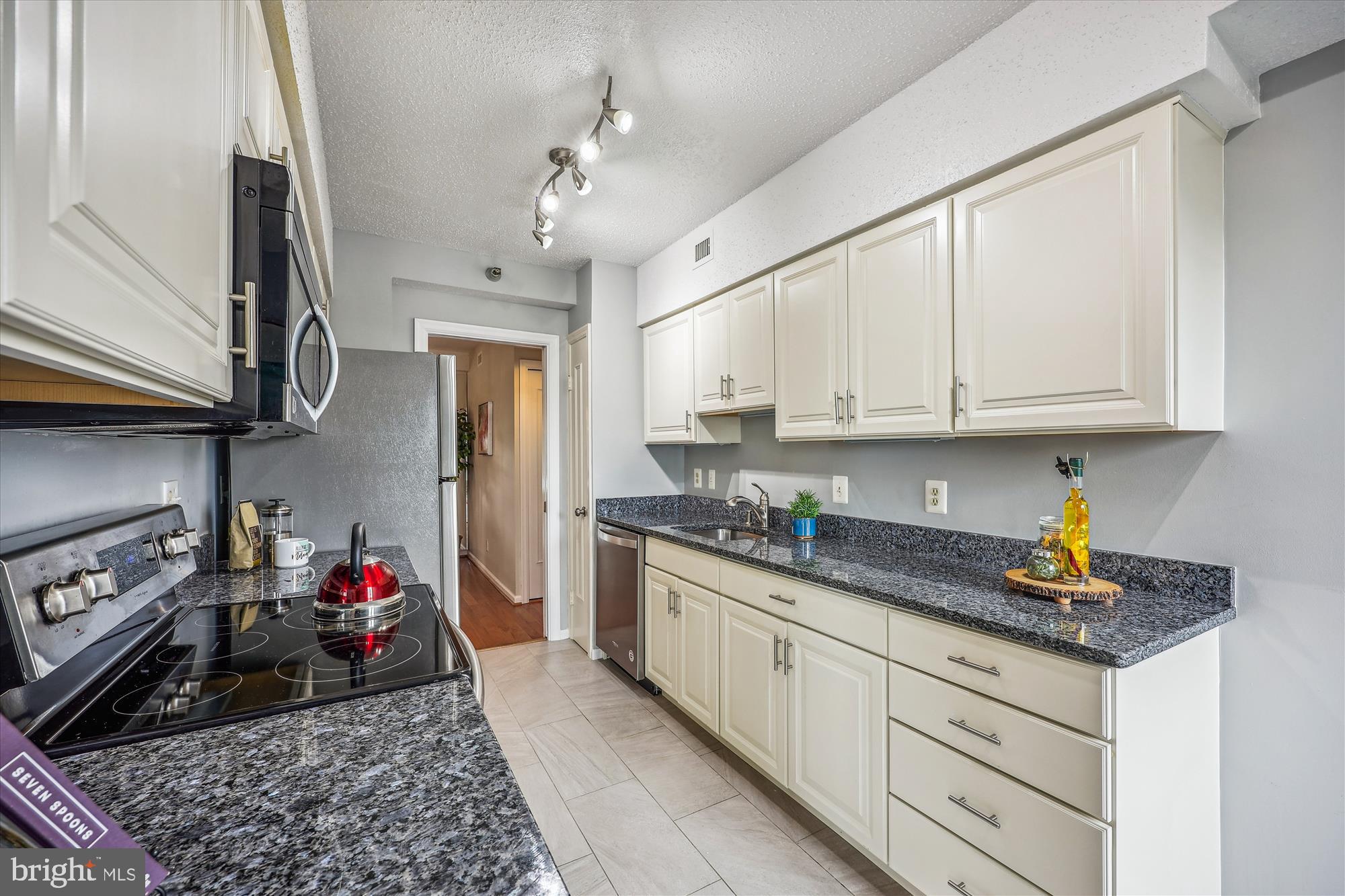 5800 Nicholson Lane, Unit 1908 Rockville, MD 20852 - Photo 9 of 35 a kitchen with stainless steel appliances granite countertop a sink dishwasher stove and refrigerator with cabinets
