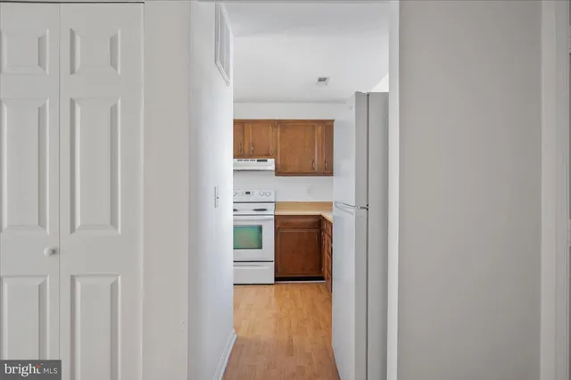 a kitchen with a sink a stove and cabinets