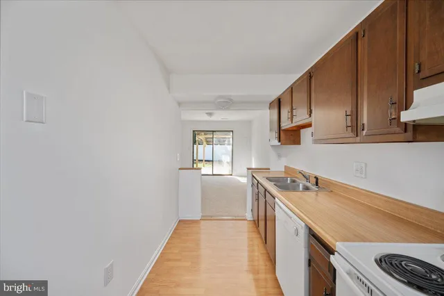 a kitchen with a sink cabinets and appliances