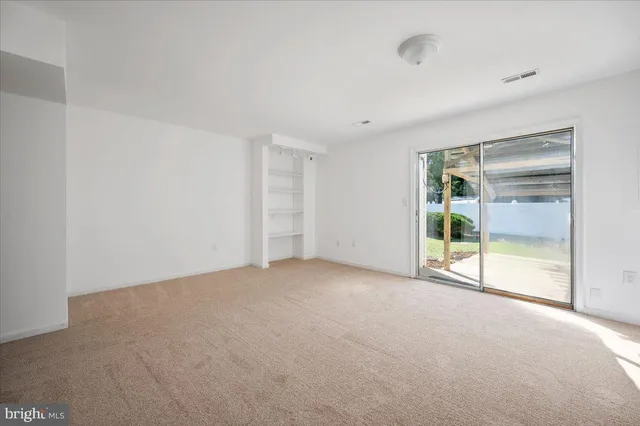 a view of empty room with a fireplace