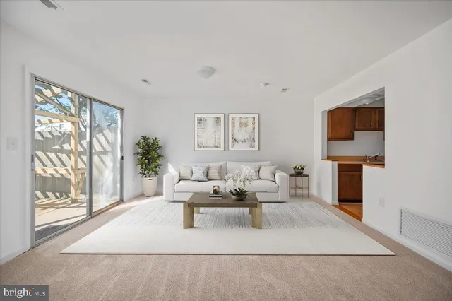 a living room with furniture a large window and a flat screen tv