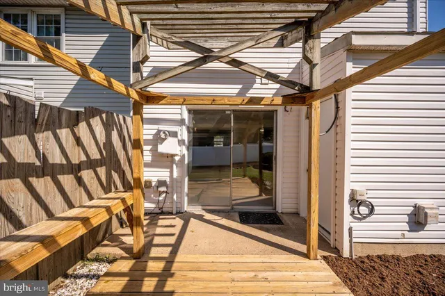 a view of a backyard with wooden fence