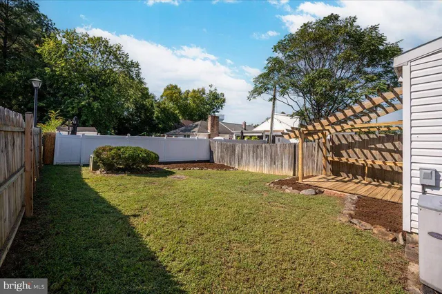a view of a house with backyard and porch