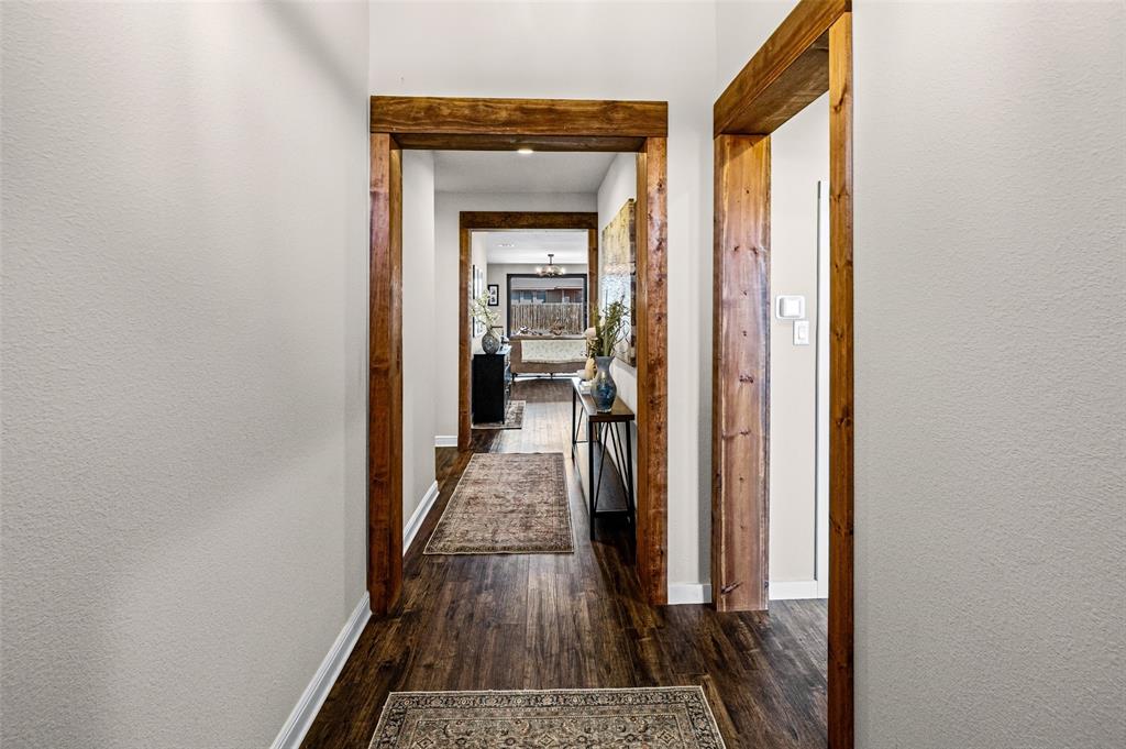 2373 Briscoe Rnch Drive Weatherford, TX 76087 - Photo 15 of 38 a view of a hallway with wooden floor and a living room