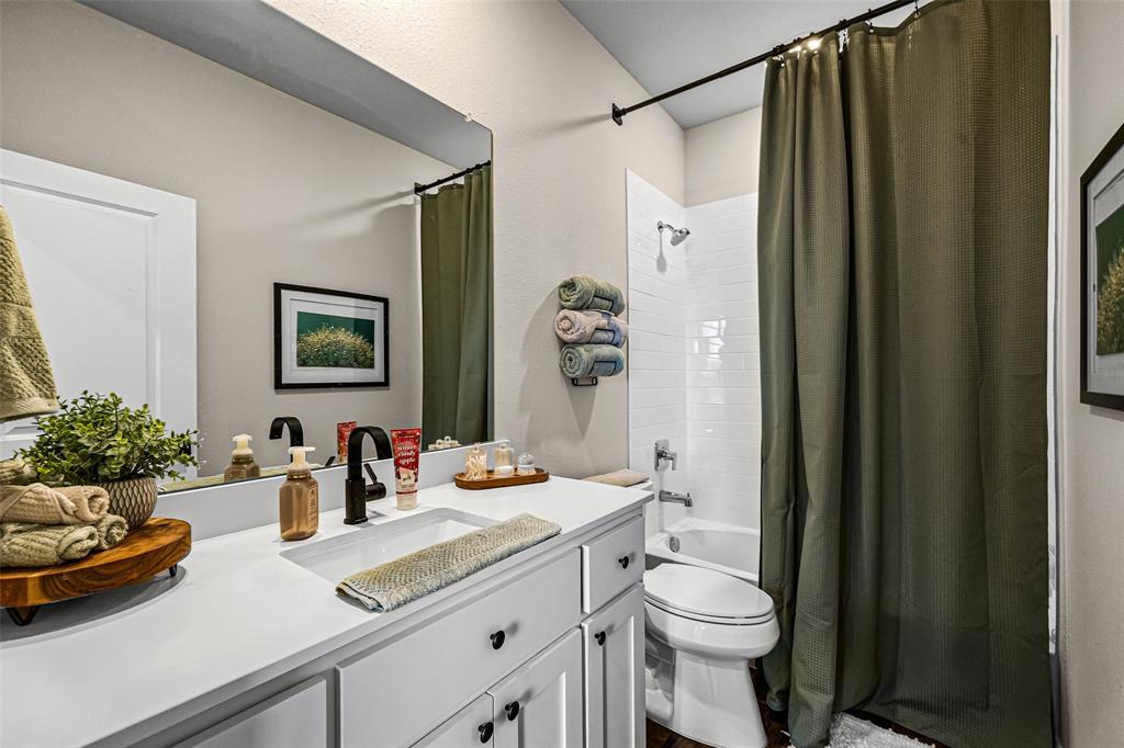 2373 Briscoe Rnch Drive Weatherford, TX 76087 - Photo 26 of 38 a bathroom with a sink a toilet and shower curtain