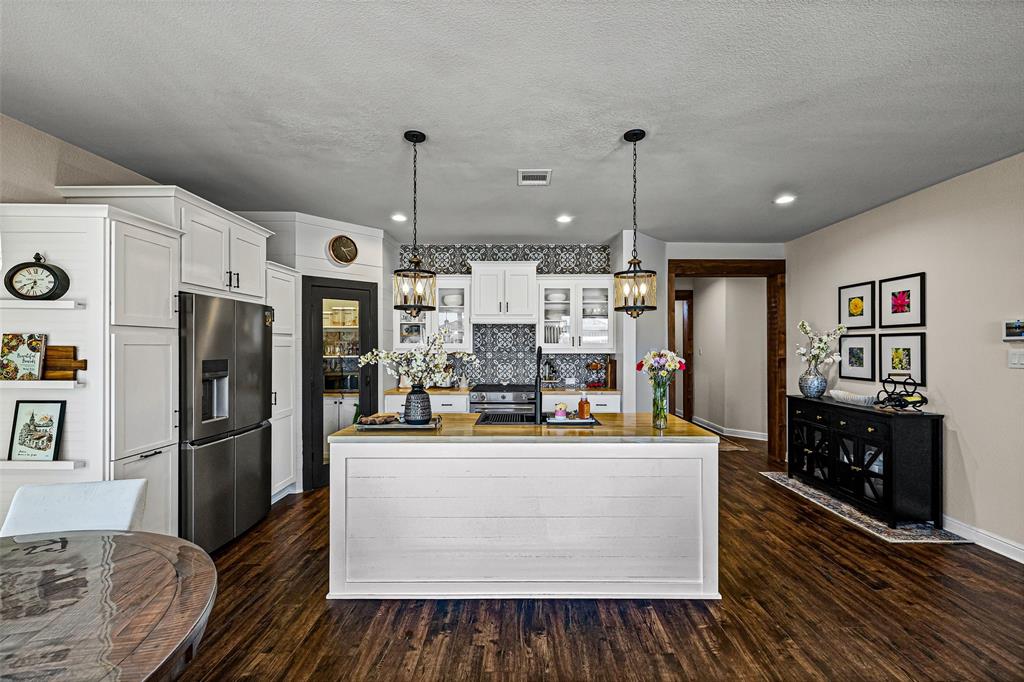 2373 Briscoe Rnch Drive Weatherford, TX 76087 - Photo 5 of 38 a view of a kitchen with refrigerator and wooden floor