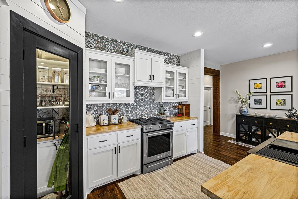 2373 Briscoe Rnch Drive Weatherford, TX 76087 - Photo 6 of 38 a kitchen with stainless steel appliances granite countertop a stove a sink and a refrigerator