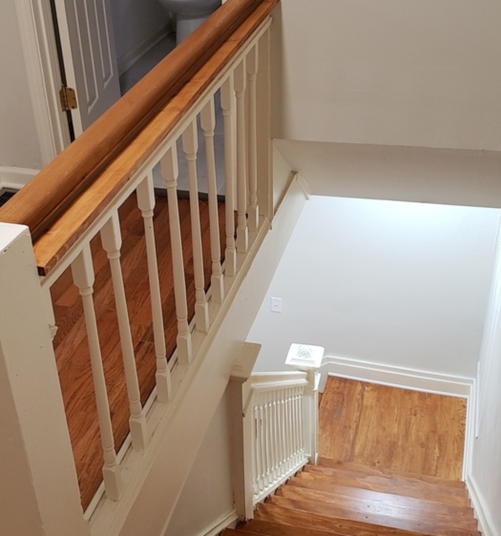 6550 South Perry Avenue Chicago, IL 60621 - Photo 5 of 6 a view of staircase with railing and white walls