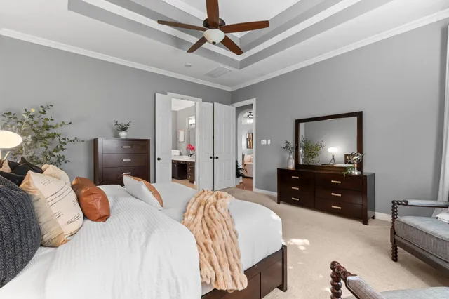 a bedroom with a bed and a chandelier