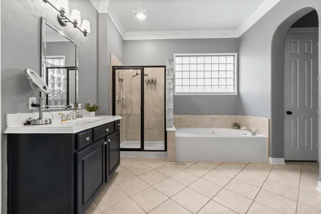 a bathroom with a tub sink and mirror