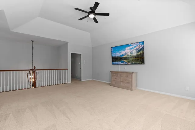 a view of a livingroom with furniture and a ceiling fan