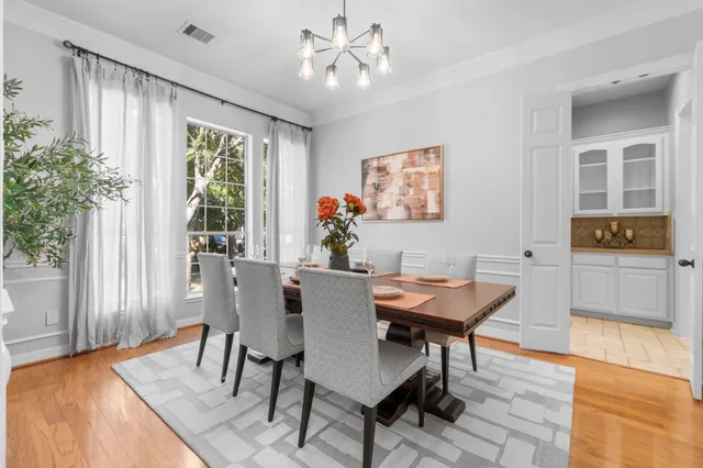 a view of a dining room with furniture and wooden floor