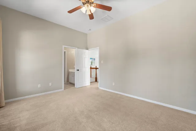 an empty room with a empty space and a ceiling fan