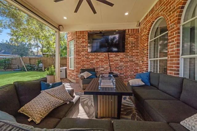 a view of a patio with couches table and chairs with garden view
