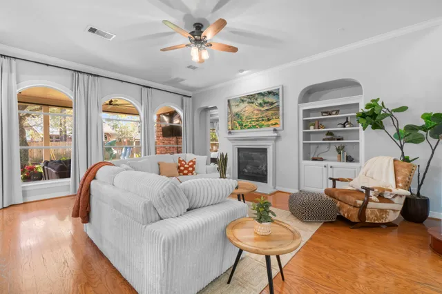 a living room with furniture a fireplace and a large window