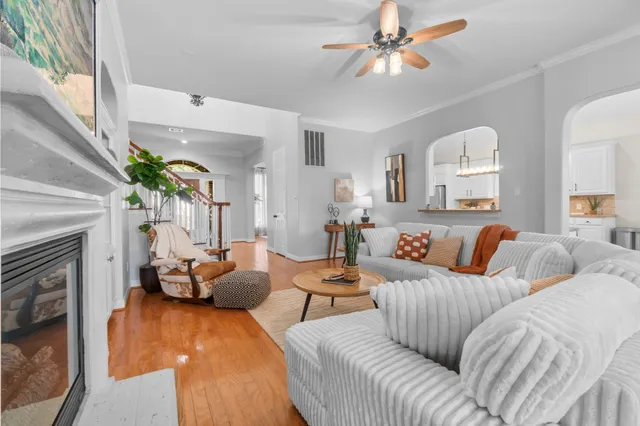 a living room with furniture a fireplace and a large window