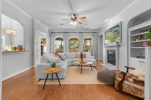 a living room with furniture fireplace and a large window