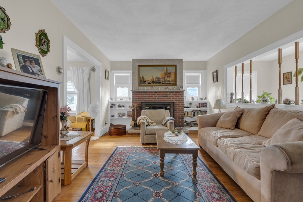 67 Bruce Road Waltham, MA 02453 - Photo 4 of 17 a living room with furniture a fireplace and a flat screen tv