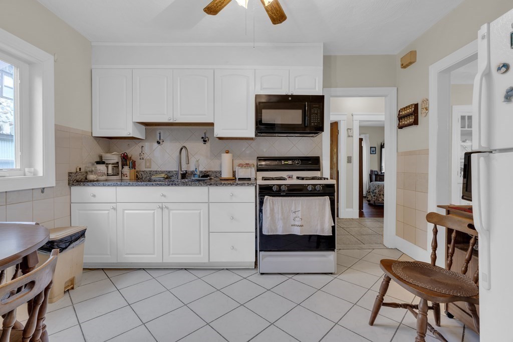 67 Bruce Road Waltham, MA 02453 - Photo 6 of 17 a kitchen with stainless steel appliances kitchen island granite countertop a sink and a stove
