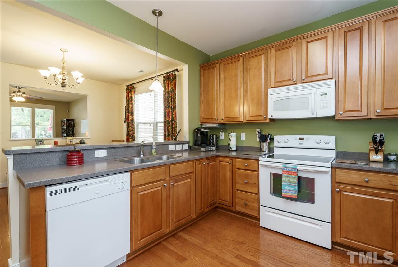 4422 Crystal Breeze Street Raleigh, NC 27614 - Photo 12 of 25 a kitchen with a stove sink and cabinets