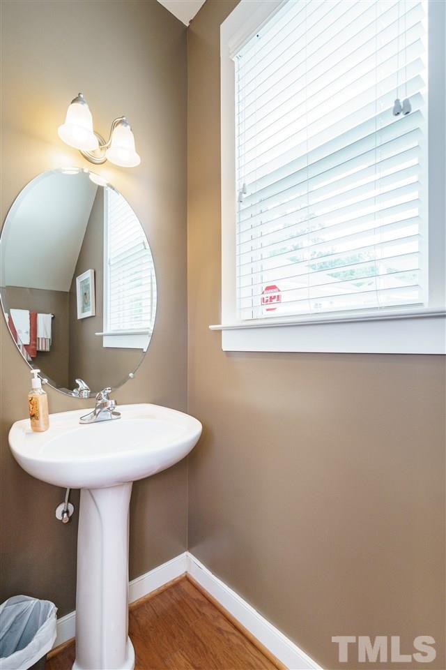 4422 Crystal Breeze Street Raleigh, NC 27614 - Photo 14 of 25 a bathroom with a sink a mirror and a window