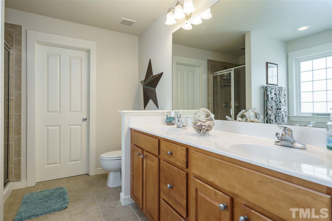 4422 Crystal Breeze Street Raleigh, NC 27614 - Photo 17 of 25 a bathroom with a sink double vanity and a mirror