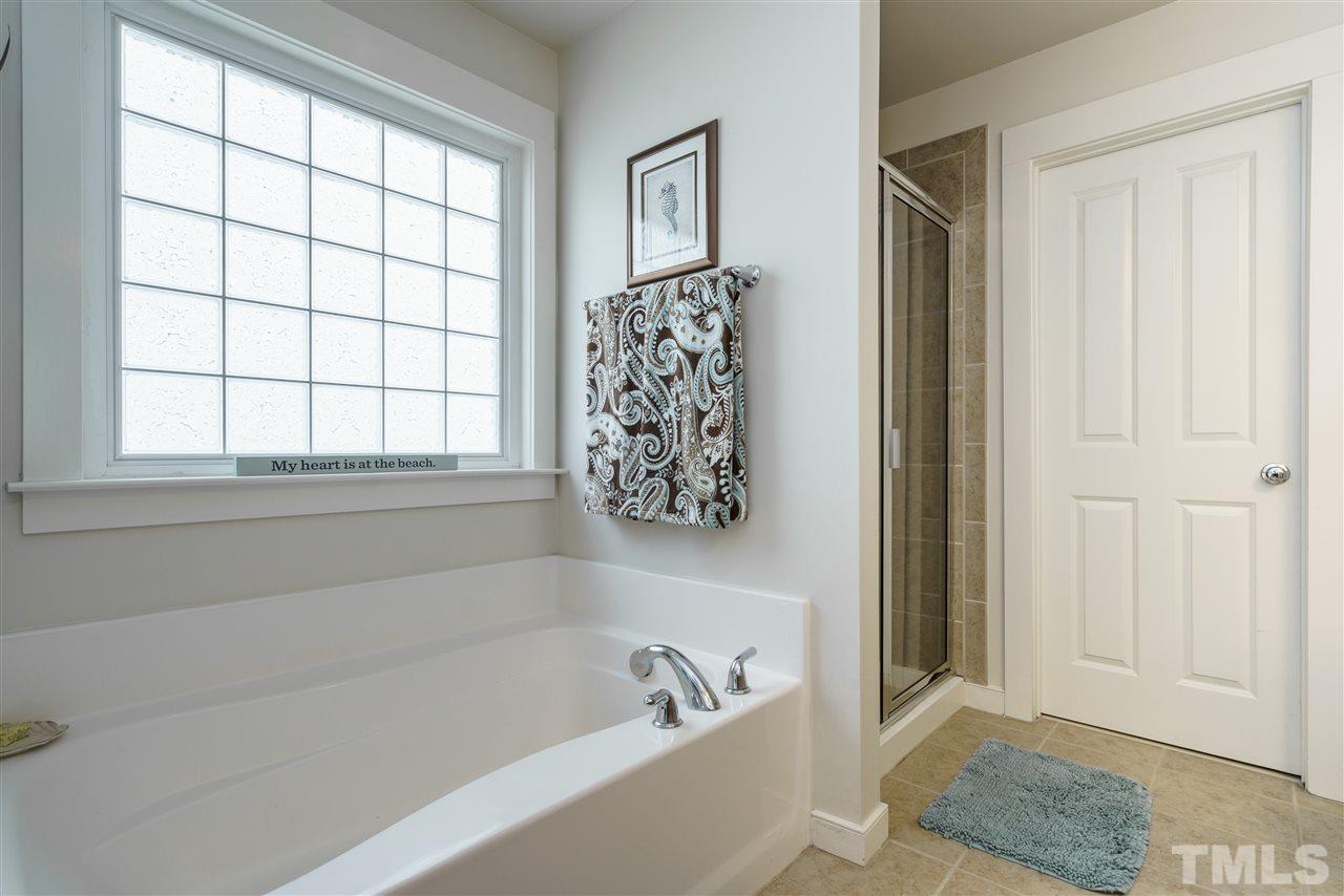 4422 Crystal Breeze Street Raleigh, NC 27614 - Photo 18 of 25 a bathroom with a bathtub and window
