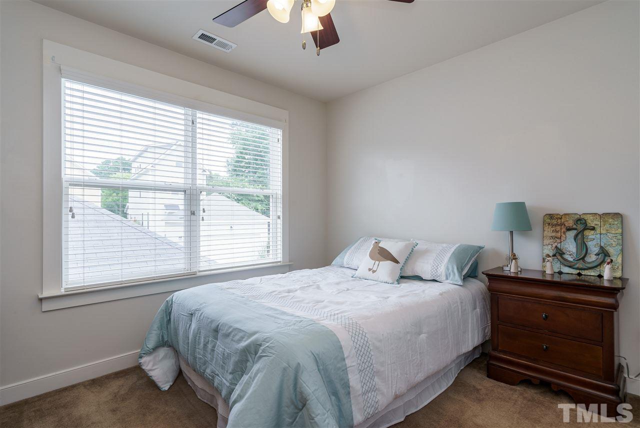 4422 Crystal Breeze Street Raleigh, NC 27614 - Photo 20 of 25 a bedroom with a bed and a window