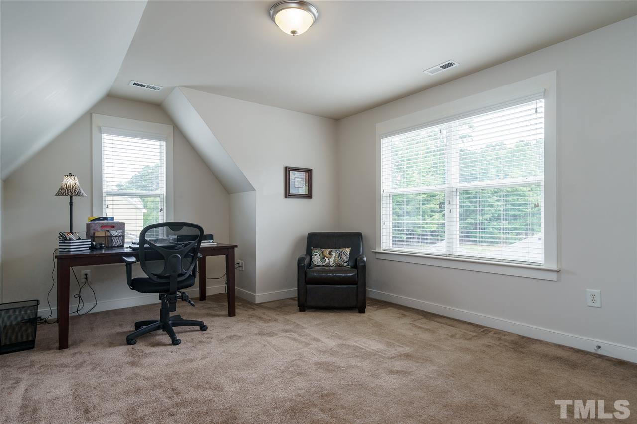 4422 Crystal Breeze Street Raleigh, NC 27614 - Photo 22 of 25 a view of a workspace with furniture and a window