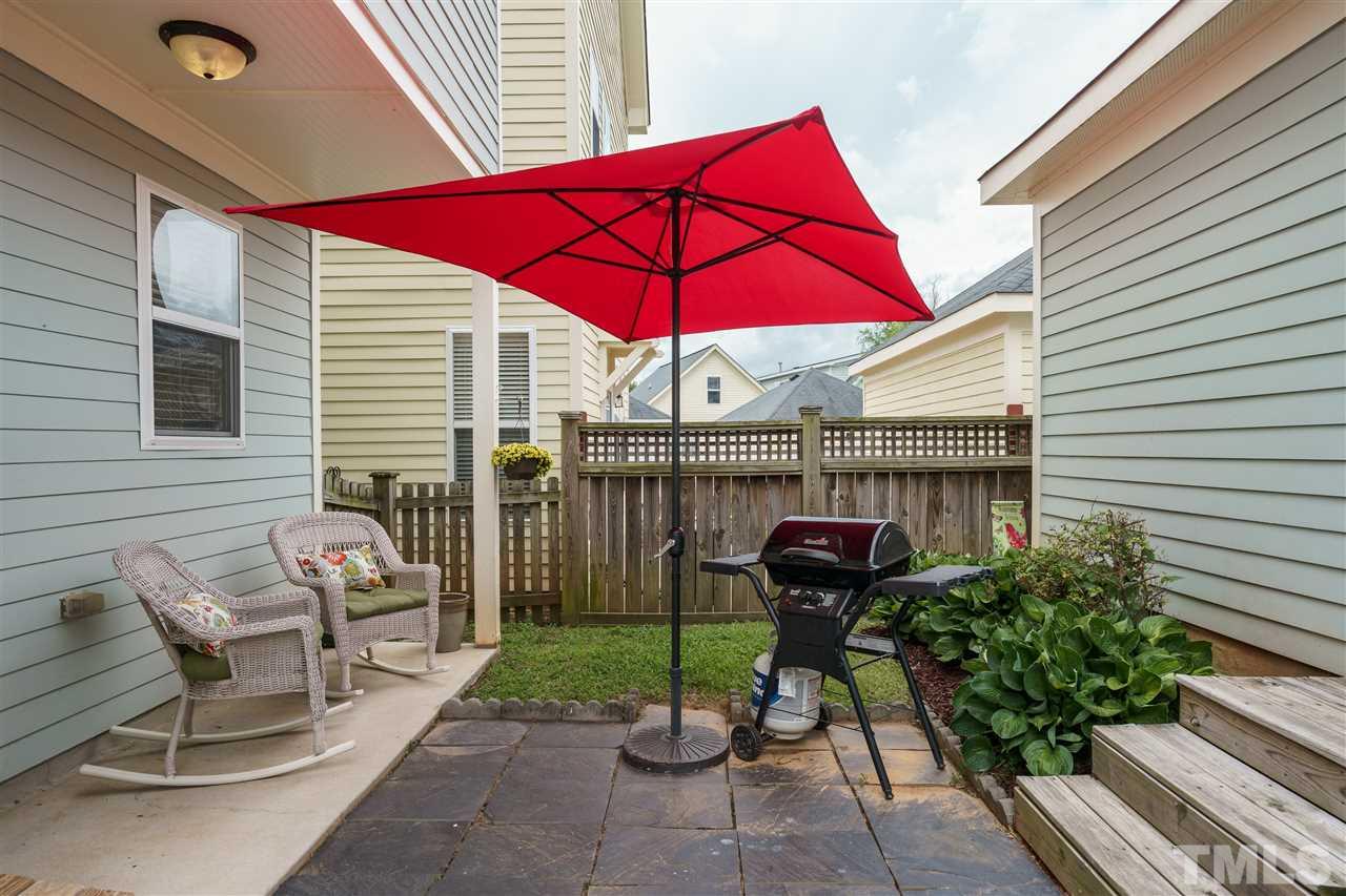 4422 Crystal Breeze Street Raleigh, NC 27614 - Photo 23 of 25 a patio with a table and chairs under an umbrella
