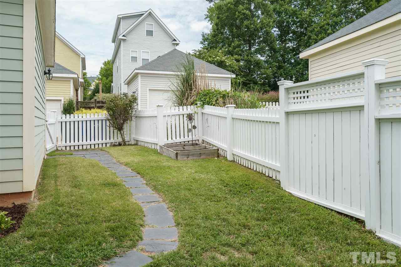 4422 Crystal Breeze Street Raleigh, NC 27614 - Photo 24 of 25 a view of a house with a small yard and wooden fence