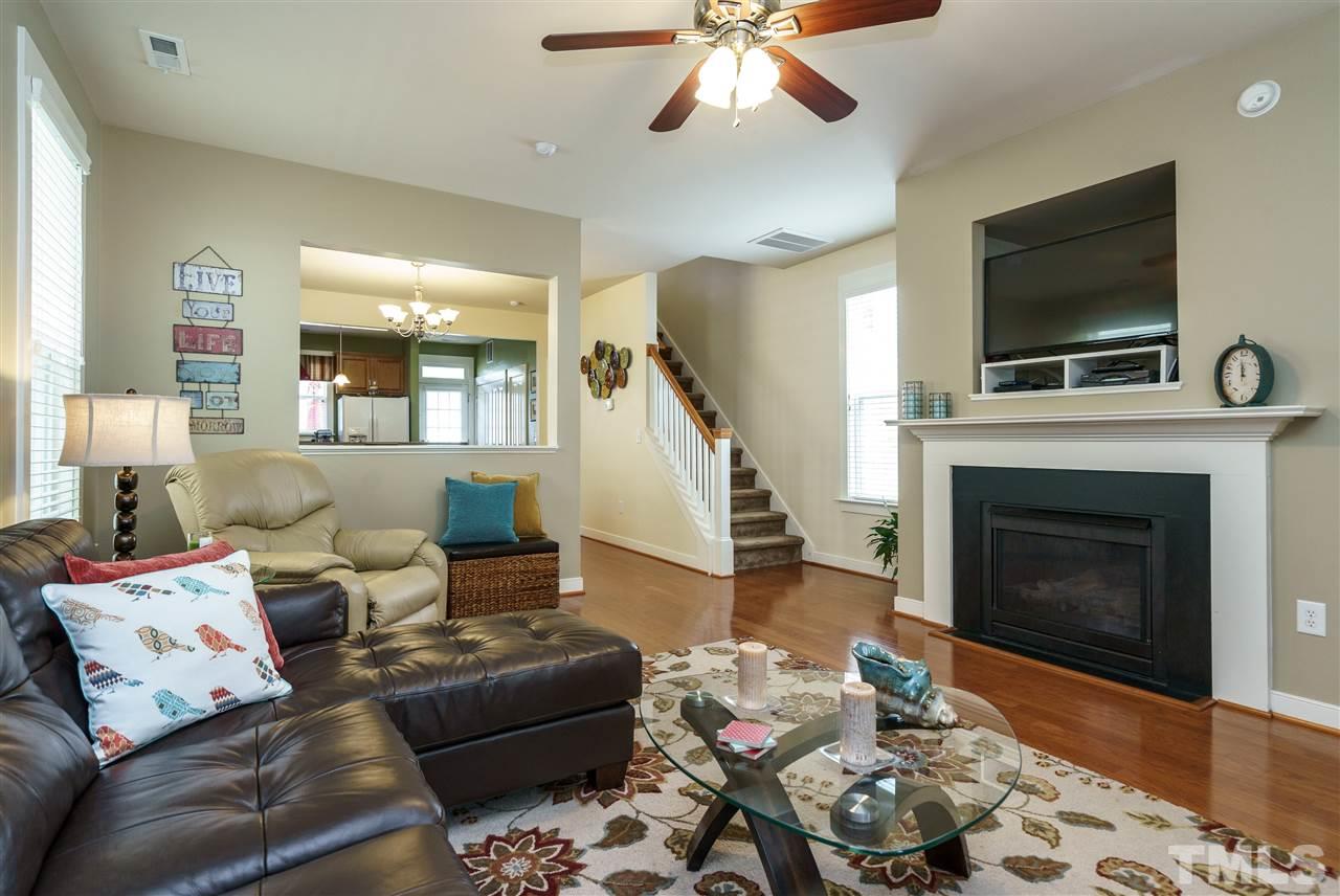 4422 Crystal Breeze Street Raleigh, NC 27614 - Photo 5 of 25 a living room with furniture a flat screen tv and a fireplace