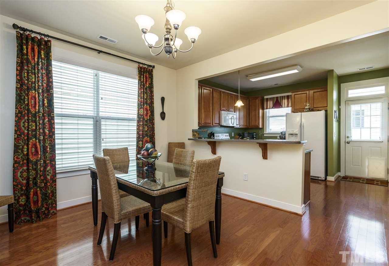 4422 Crystal Breeze Street Raleigh, NC 27614 - Photo 8 of 25 a view of a dining room with furniture window and wooden floor