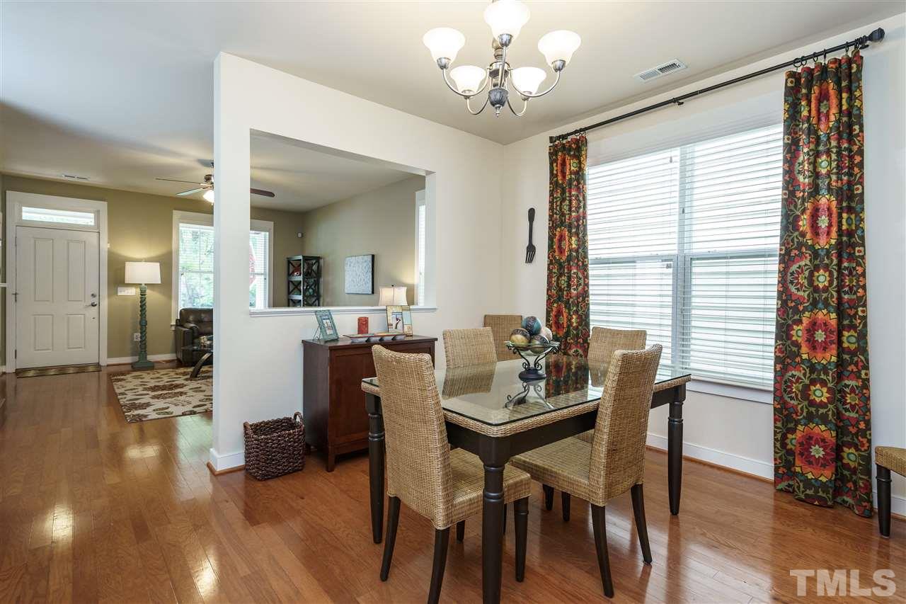 4422 Crystal Breeze Street Raleigh, NC 27614 - Photo 9 of 25 a view of a dining room with furniture window and wooden floor