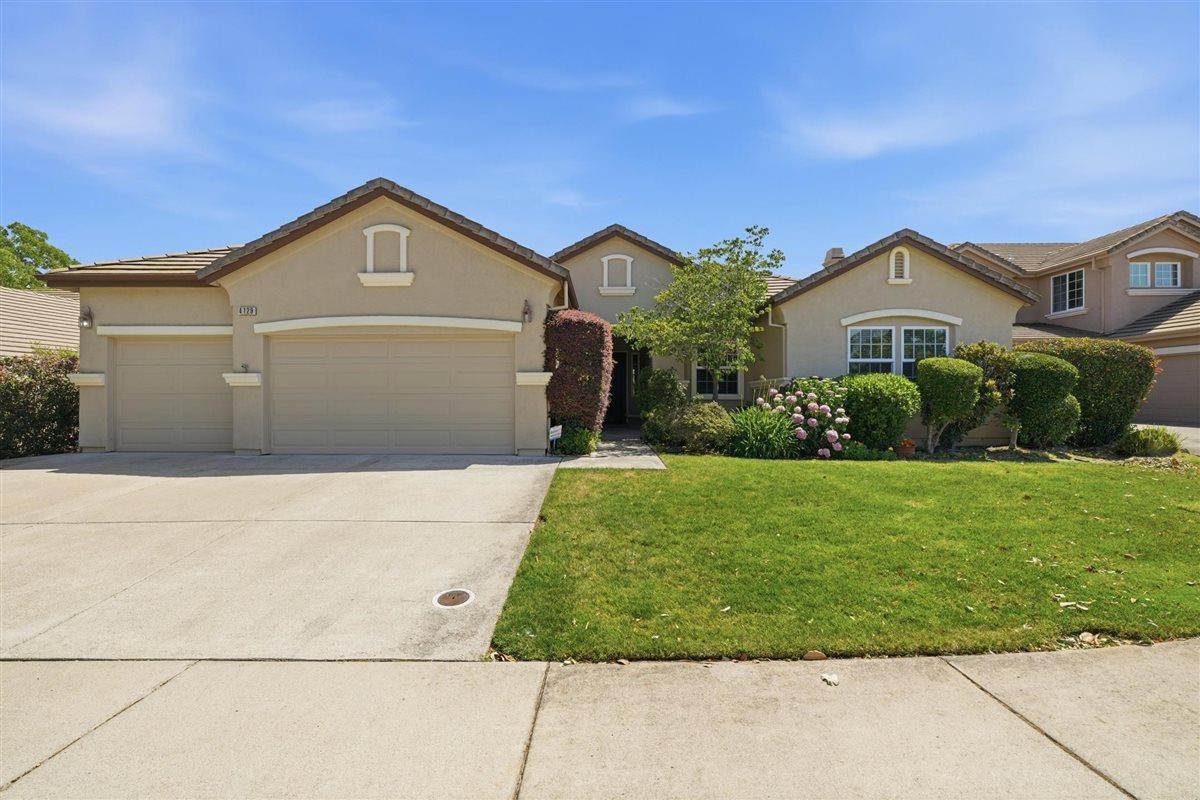 4129 Poppleton Way Carmichael, CA 95608 - Photo 1 of 48 a front view of a house with a yard