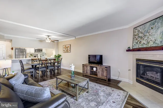 a living room with furniture a dining table and a chandelier
