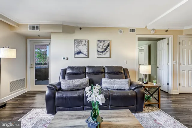 a living room with furniture and wooden floor