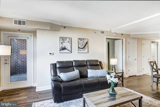 a living room with a fireplace and a painting on the wall