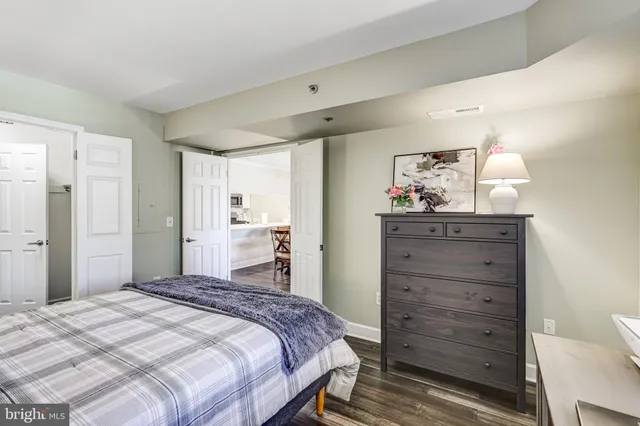 a bedroom with a bed and a mirror