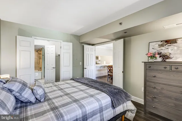 a bedroom with a bed and wooden floor