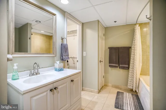 a bathroom with a sink a mirror and a shower