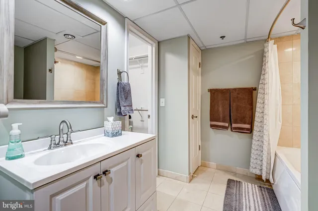 a bathroom with a bathtub shower sink and toilet