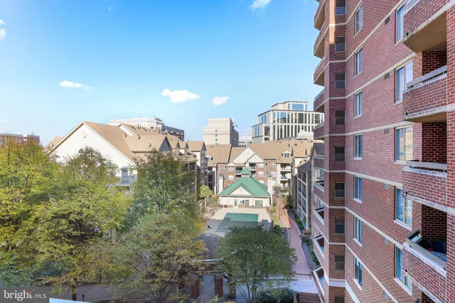 a living room with furniture and large windows