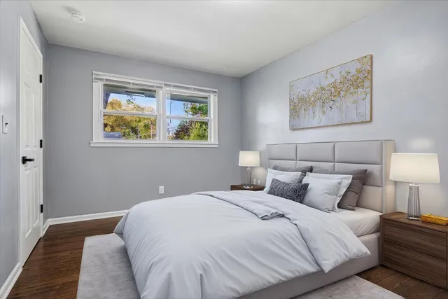 a bedroom with bed and painting on the wall